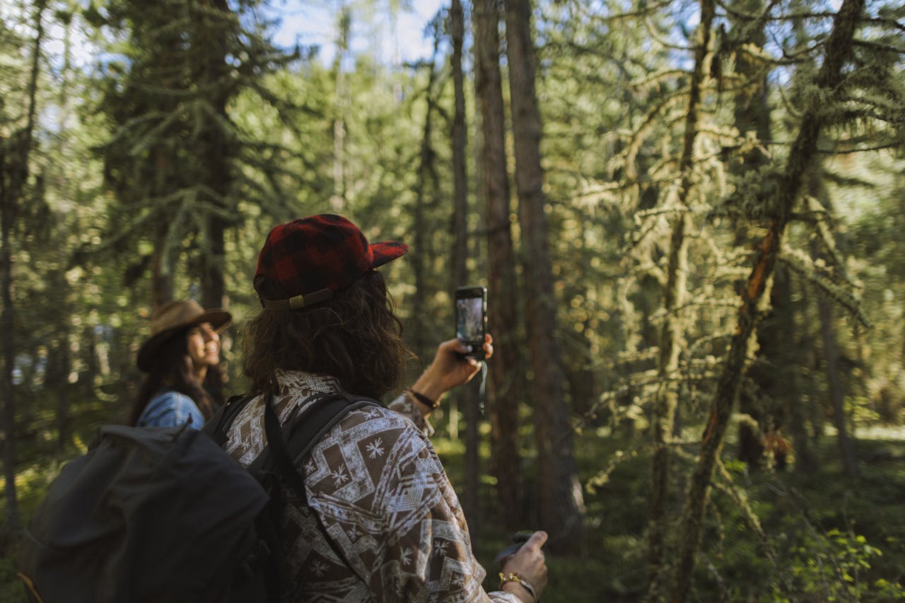 a couple in a forest taking photos